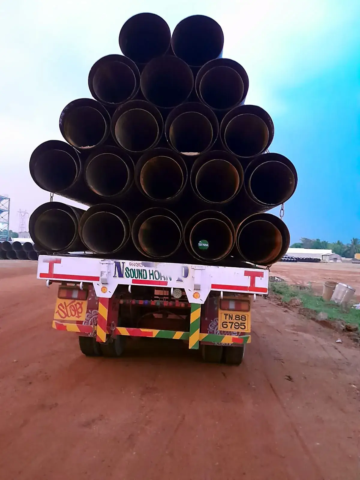 Pyramid of steel pipes chained onto a trailer